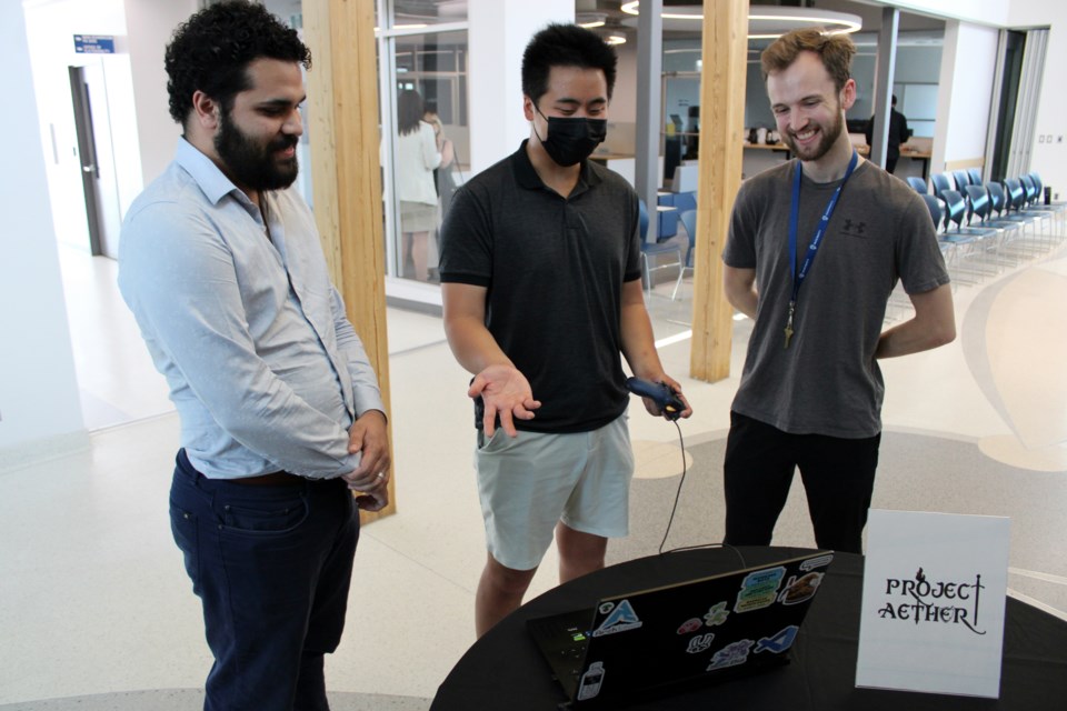 1 / 2 Josiah Ledua, left, James McDonagh and Tim Shaw share a laugh while showcasing their game Project Aether during the Lakehead Ingenuity's Ascend Accelerator program graduation ceremony on Friday.Lucas Punkari, TBnewswatch.com