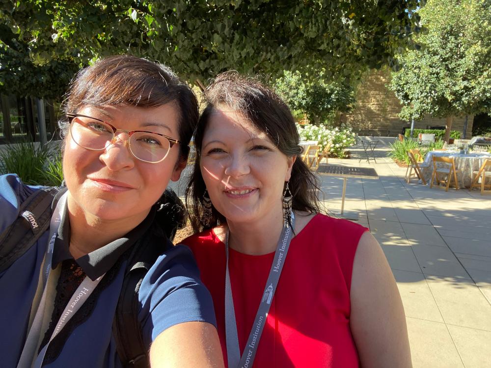 Tyna Legault Taylor, left, and Tashya Orasi attended a reception in the Fairweather Courtyard at the Hoover Institution at Stanford University.