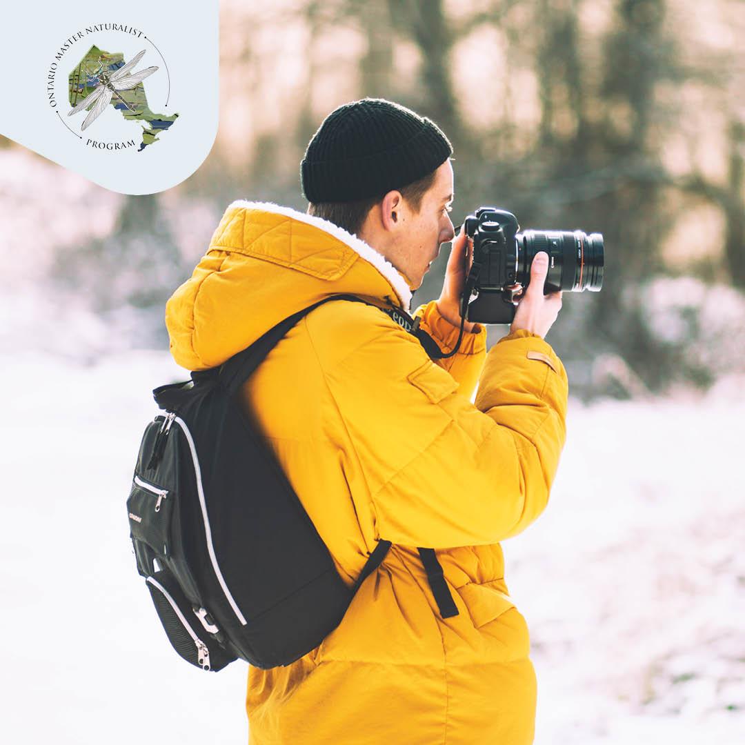 Man taking photo of nature outside winter