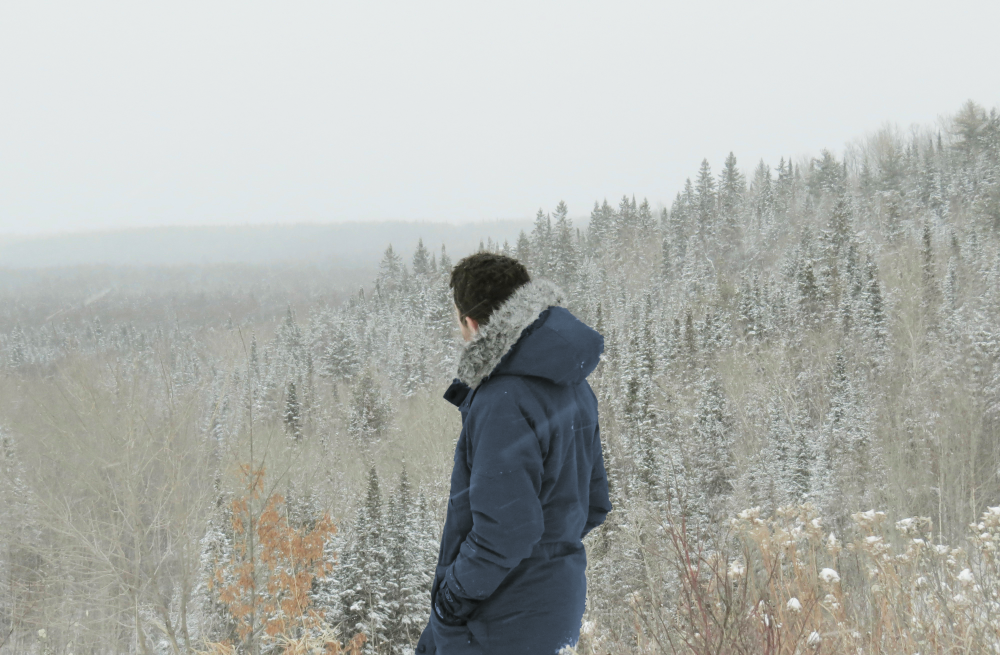 man looking out winter omnp